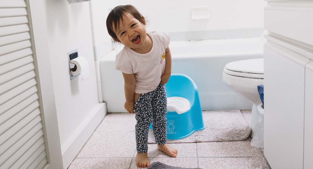 toddler girl smiling in the bathroom