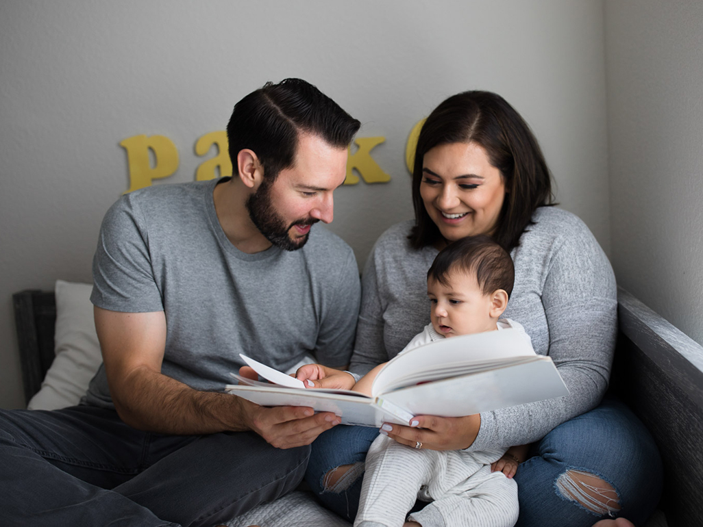 mom and dad reading to baby