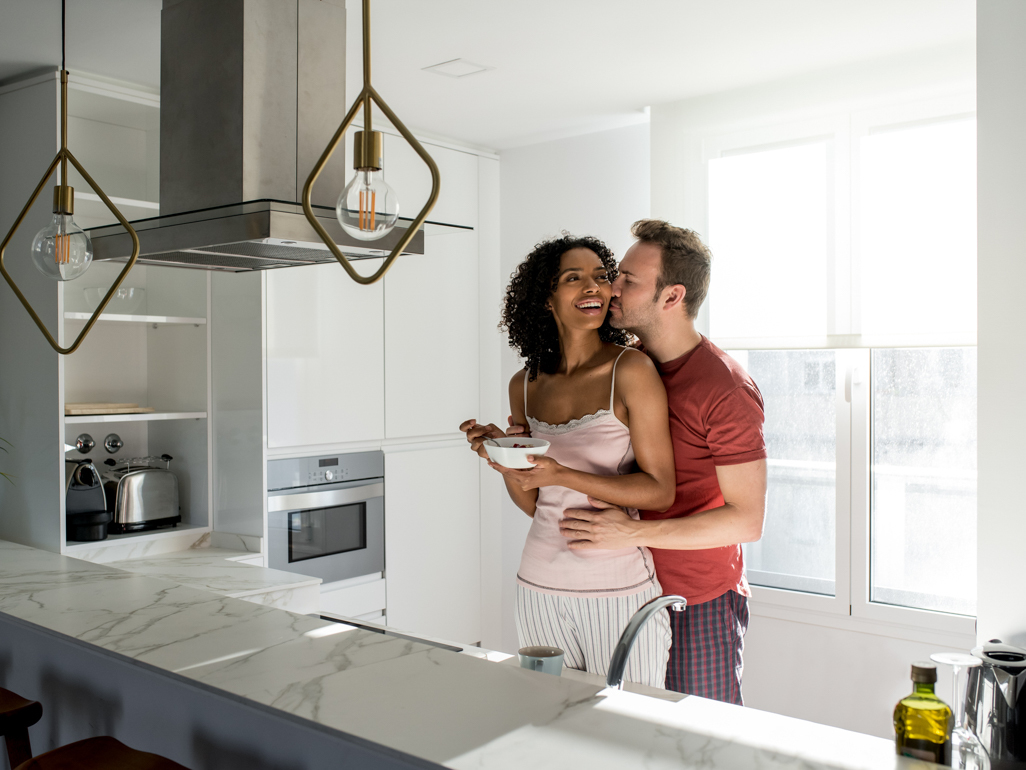 man and woman hugging in the kitchen