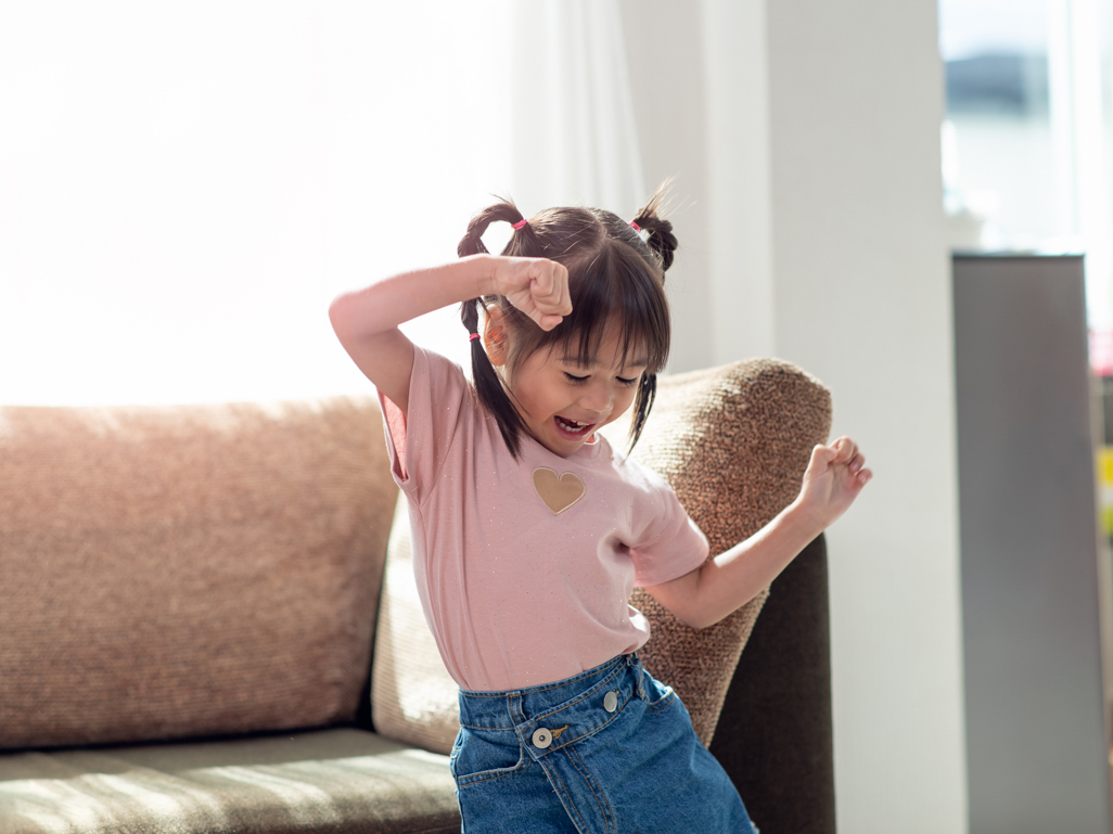 young girl dancing in her living room