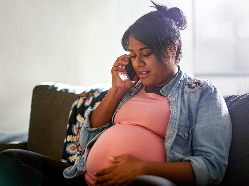 Pregnant woman on the phone with doctor