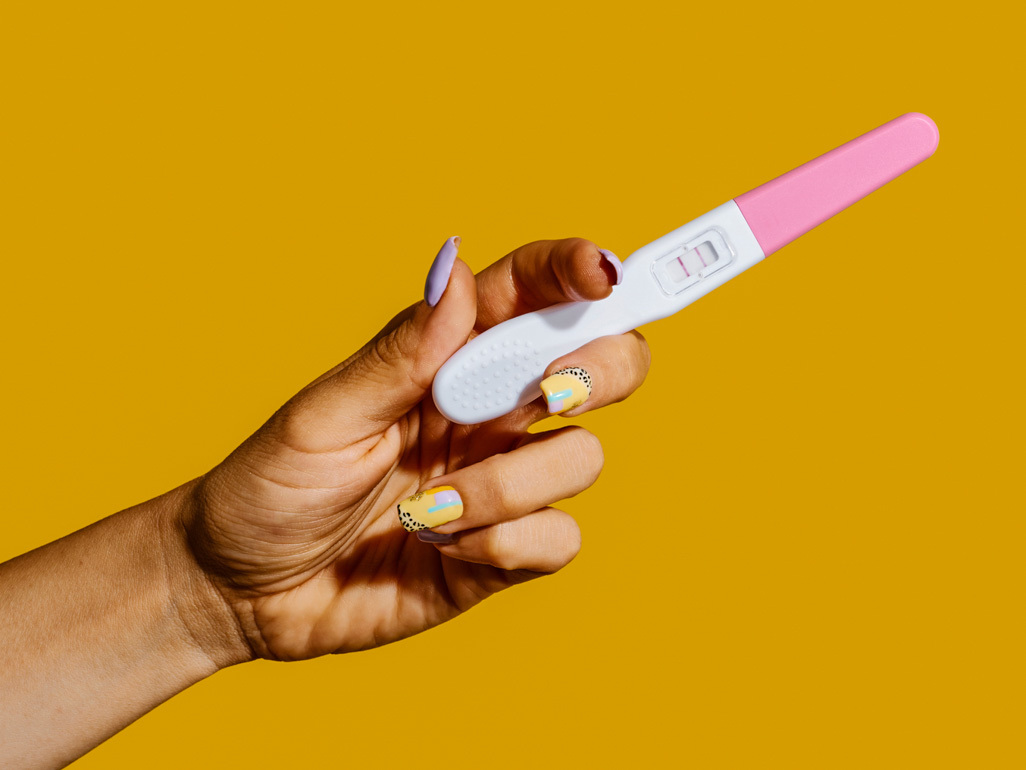 woman holding up pregnancy test