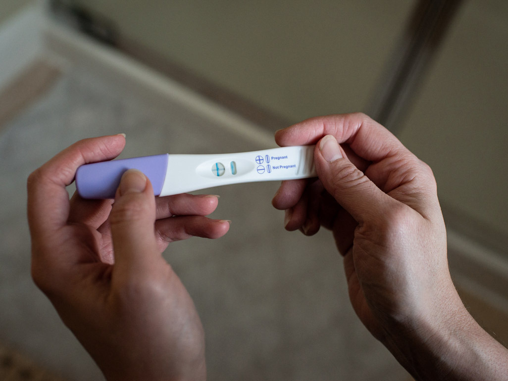 Woman holding home pregnancy test