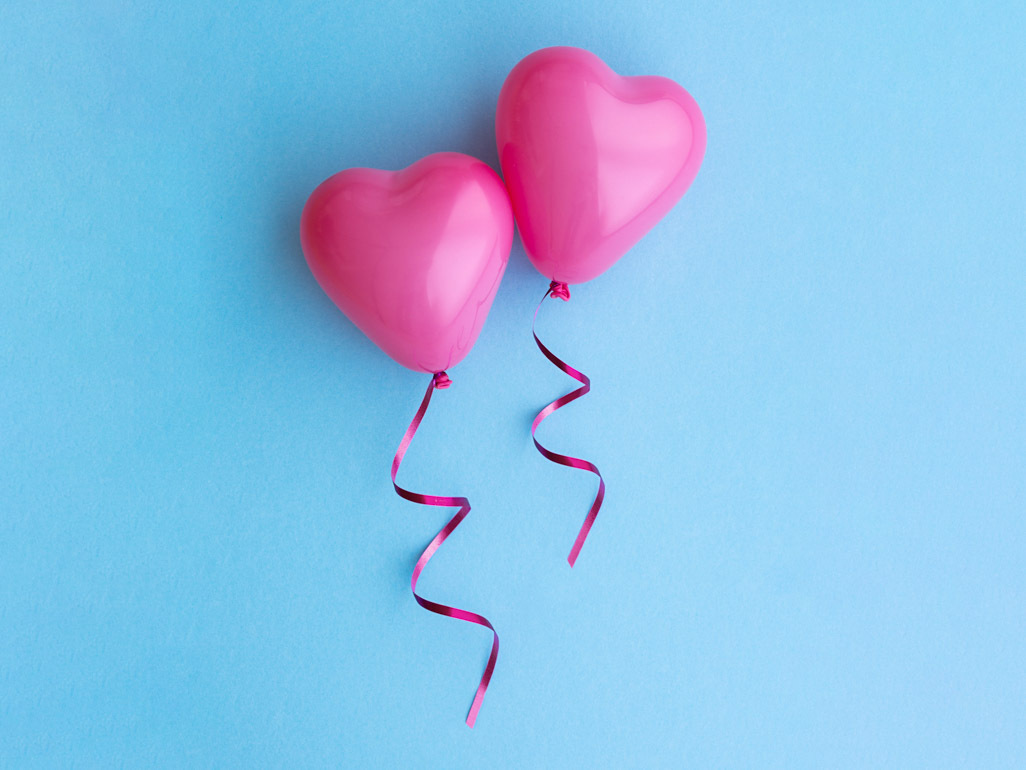 two heart balloons symbolizing a twin pregnancy test